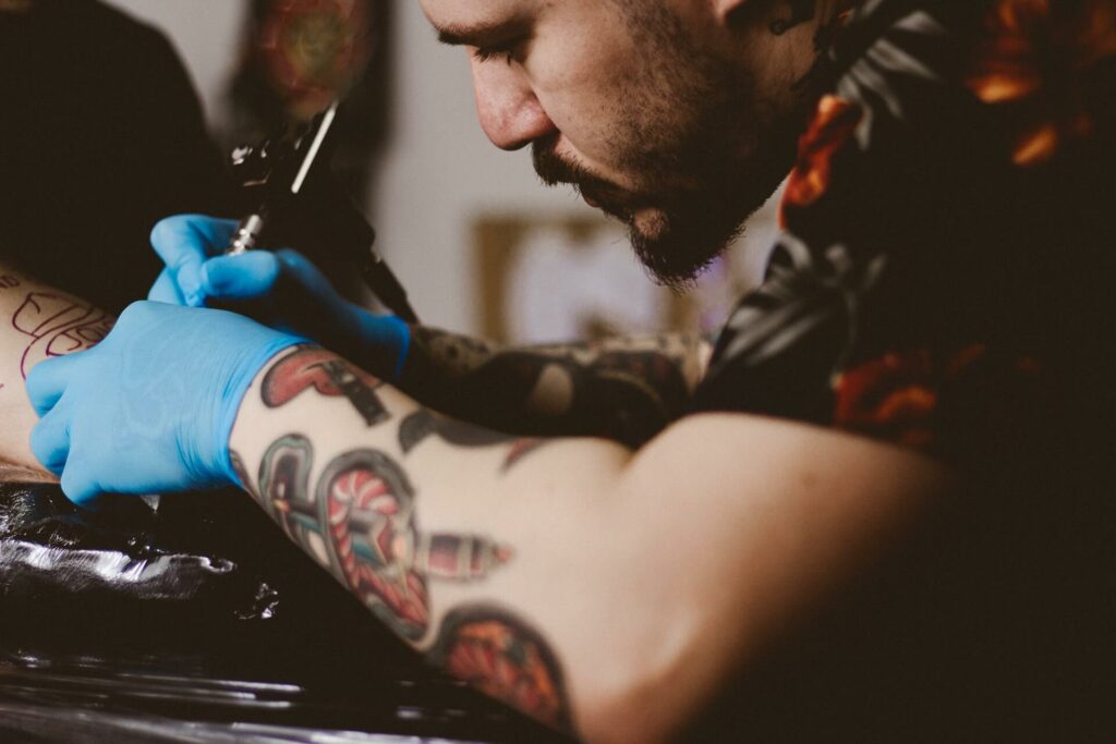 A tattoo works on a tattoo on hand