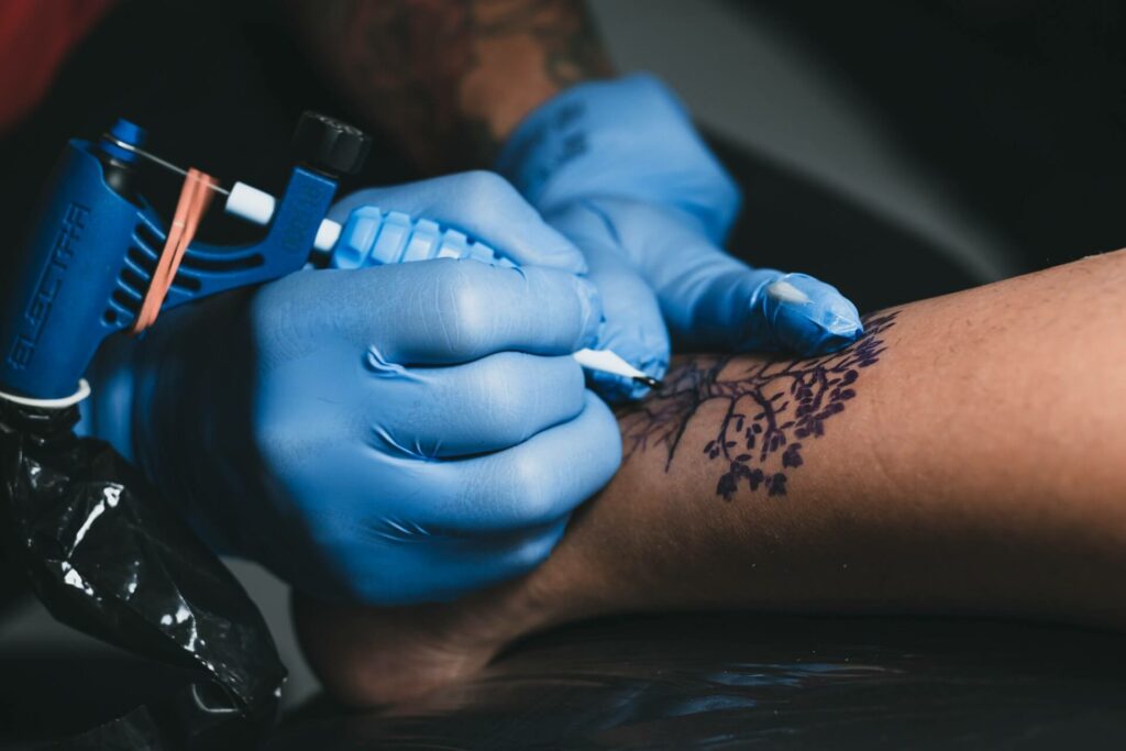 Crop master making tattoo on leg