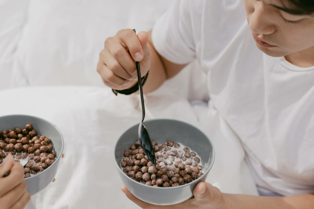 High-Angle Shot of a Man Eating Chocolate Cereal