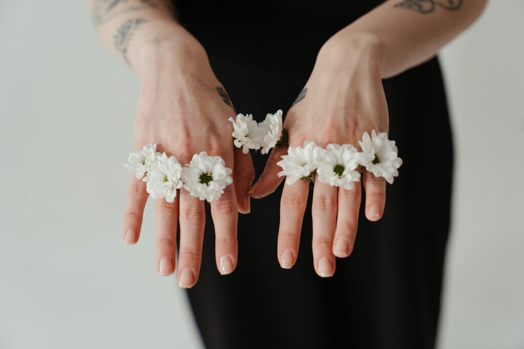 Photo of White Flowers on Person's Hands