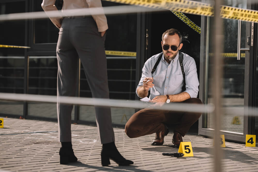 Sitting male detective in sunglasses smoking