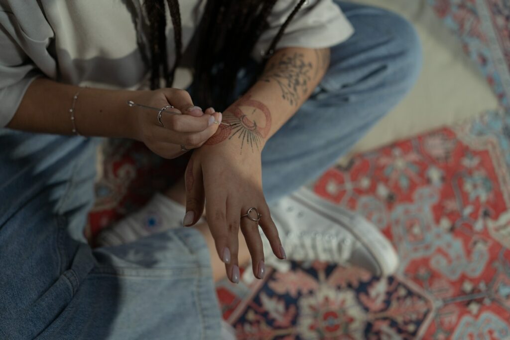 Woman Doing Hand Poke Tattoo